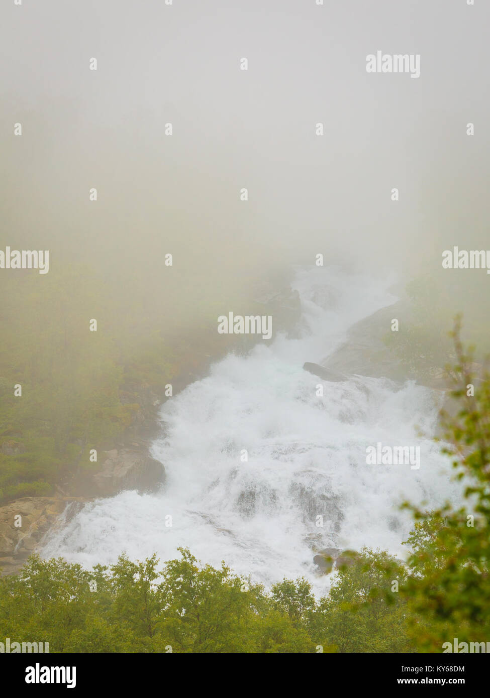 Travel, beauty in nature. Waterfall torrential river along the Aurlandsfjellet mountains in Norway Sogn og Fjordane, foggy hazy summer day Stock Photo