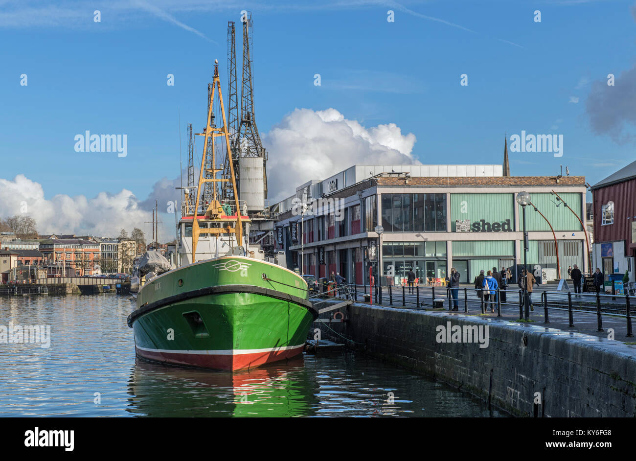 Bristol Harbour showing the MSheds and Bee, a green fishing trawler now permanently moored. Stock Photo