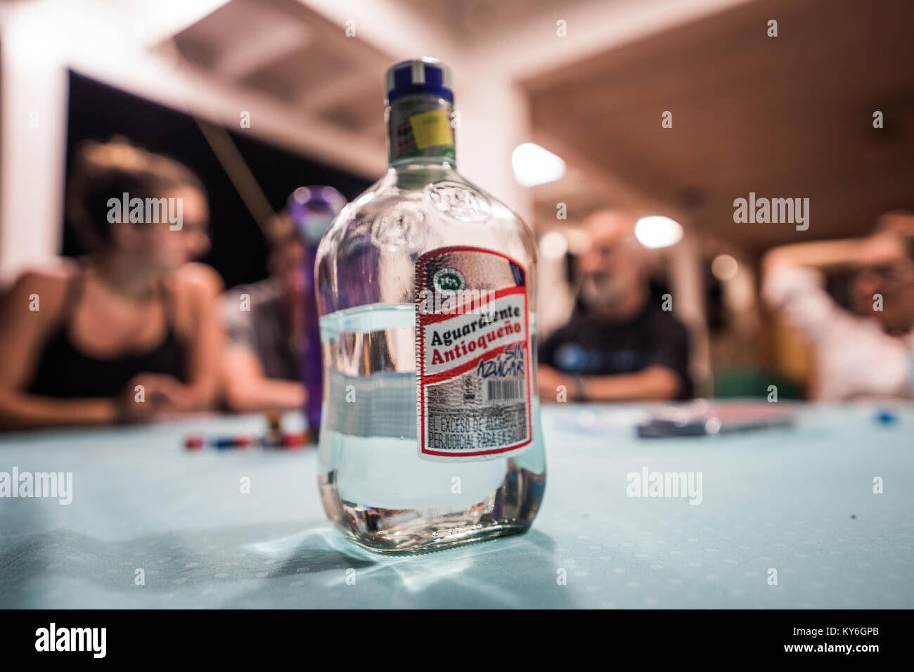 SAN ANDRES ISLAND, Colombia   Circa March 2017. Group of Adults playing Dice Game and Drinking Local Aguardiente at Night on the Balcony. Stock Photo