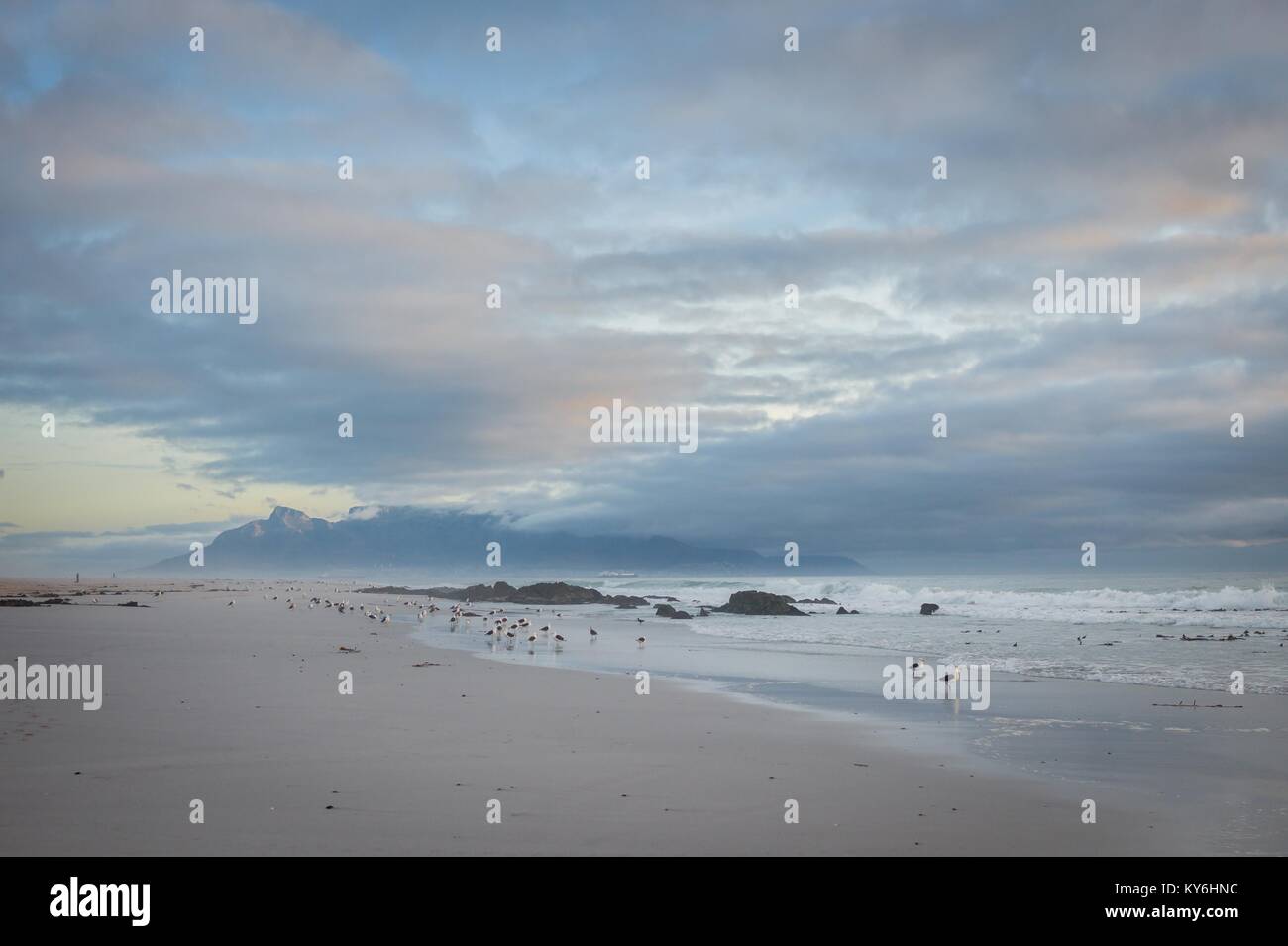 View of Table Mountain National Park in Cape Town from Blouberg Beach at sunset Stock Photo