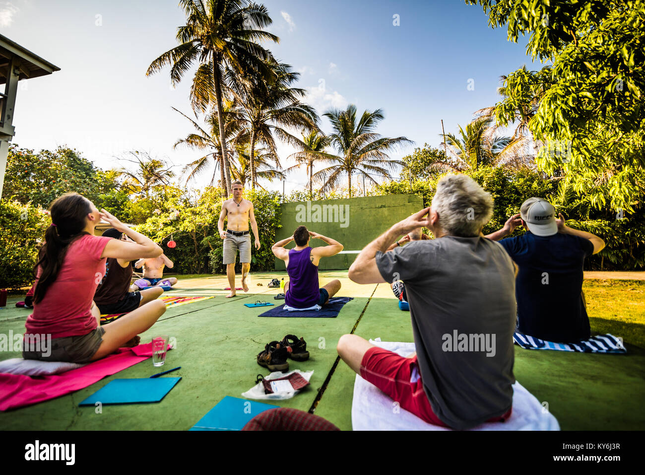 SAN ANDRES ISLAND, Colombia   Circa March 2017. Group of People in a Outdoor Pranayama Class doing Breathing Exercises Early in the Morning. Stock Photo