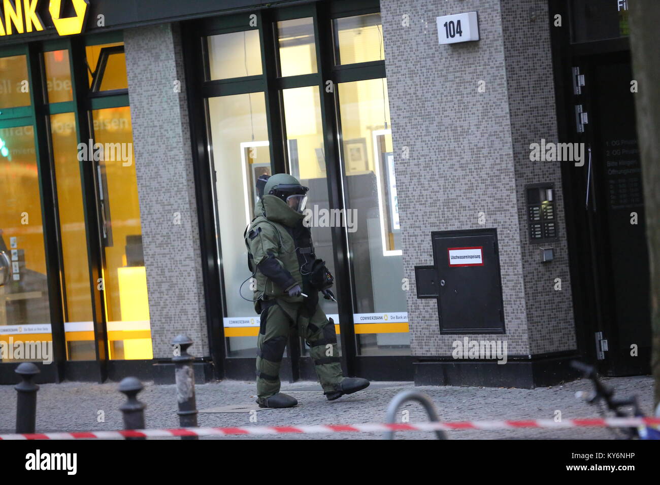 Berlin, Germany. 12th Jan, 2018. In a Commerzbank branch in the Berlin district of Steglitz, a suspicious Din-A4 sized mailing bag was discovered on Friday afternoon. The police specialists removed the detonator in protective suits and had a robot in use to further investigate the item for explosives. The investigators discovered in the mailing a explosive material such as black powder, but this could not trigger a large detonation, as a police spokesman said. Credit: Simone Kuhlmey/Pacific Press/Alamy Live News Stock Photo