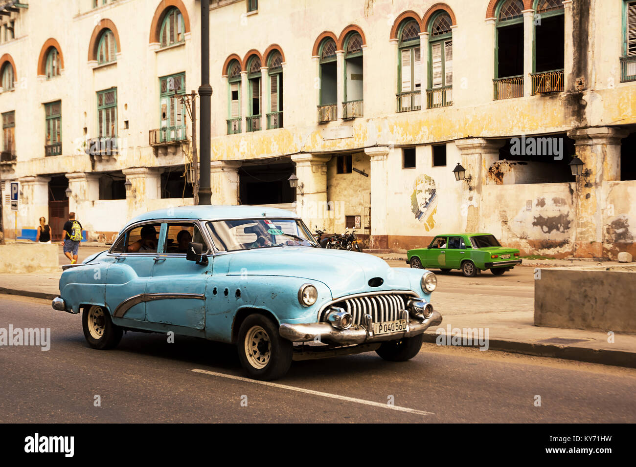 Havana, Cuba - December 3, 2017: blue, old and classical car in road of old Havana (Cuba) and in the background the icon of Che Stock Photo