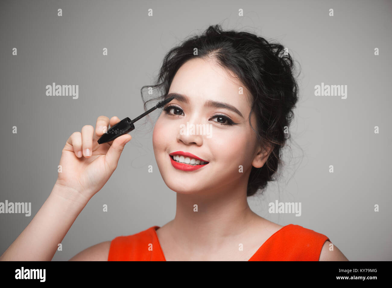 An asian woman applying mascara on her eyelashes Stock Photo Alamy