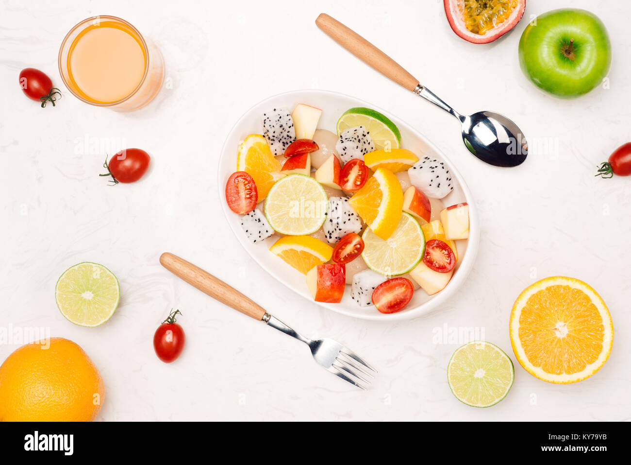Fresh mixed fruit salad falling into a bowl of salad Stock Photo - Alamy