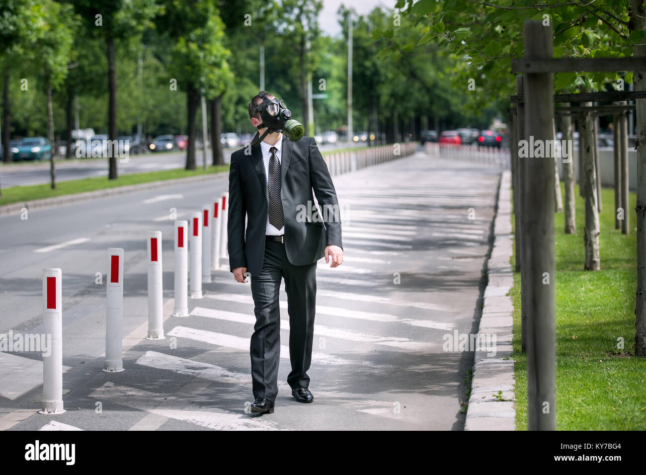 Businessman wearing a gas mask looking to the sky Stock Photo - Alamy