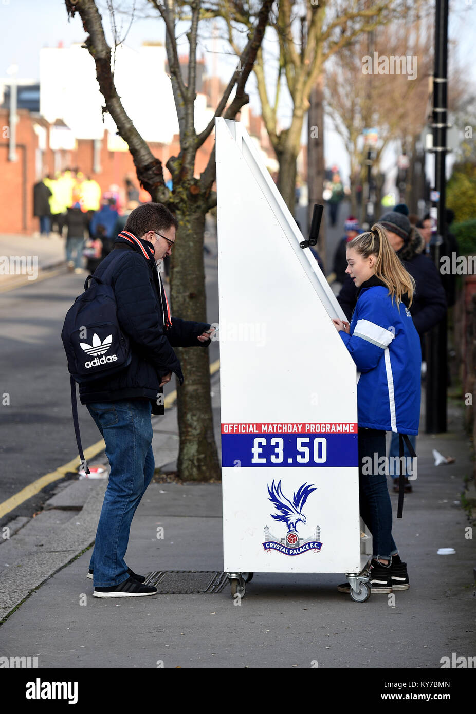 A vendor sells match day programmes during the Premier League match at ...