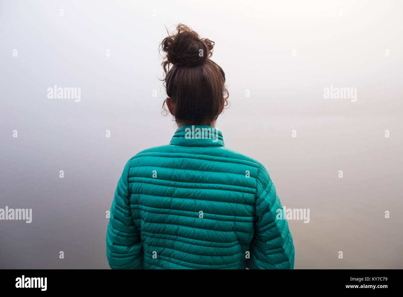 MAYNOOTH, ONTARIO, CANADA - October 18, 2017: A lady looks at a foggy lake in the autumn. Stock Photo
