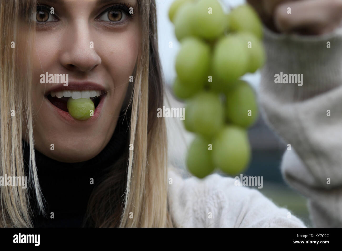 Woman eating grapes hi-res stock photography and images - Alamy