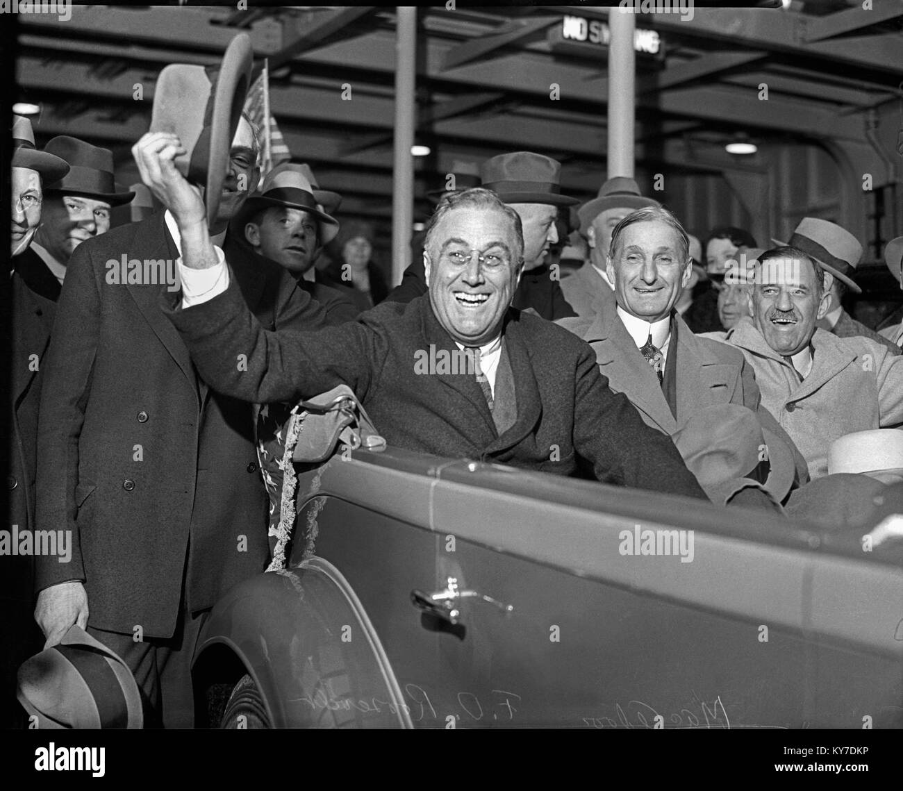 Franklin Roosevelt arrives in San Francisco, just before the 1932 election to deliver an economic speech to the Commonwealth Club. Riding in the car with FDR is, William G. McAdoo and Justes Wardell. September 24, 1932. Stock Photo