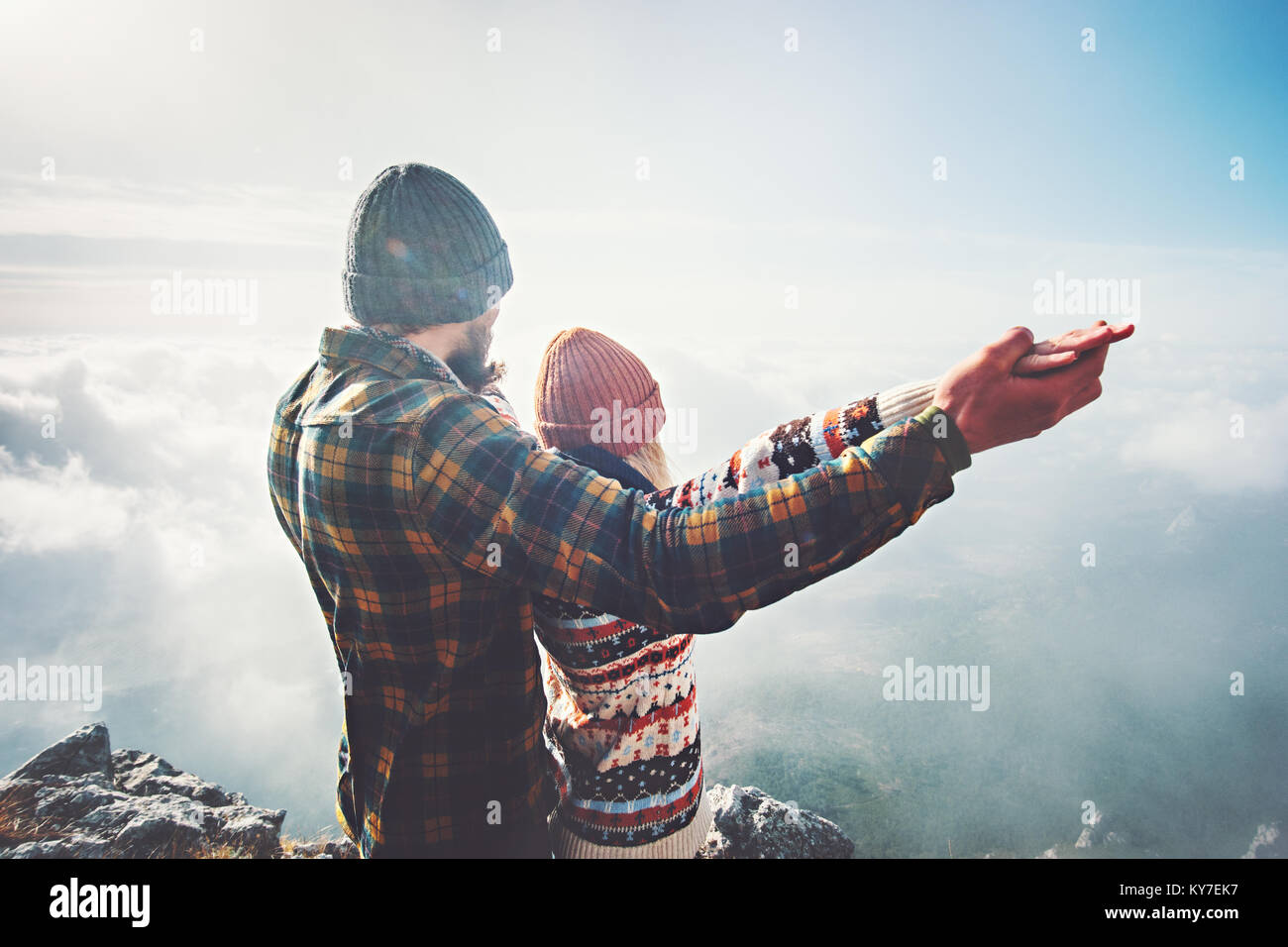 Couple Man and Woman holding hands raised on mountain summit Love and Travel happy emotions feelings Lifestyle concept. Young family traveling active  Stock Photo