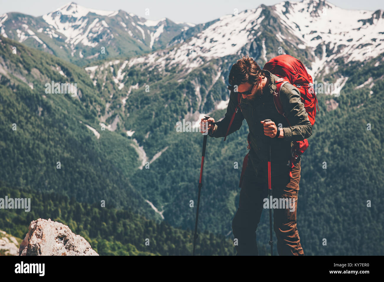 Man traveler with backpack hiking in mountains Travel Lifestyle concept ...
