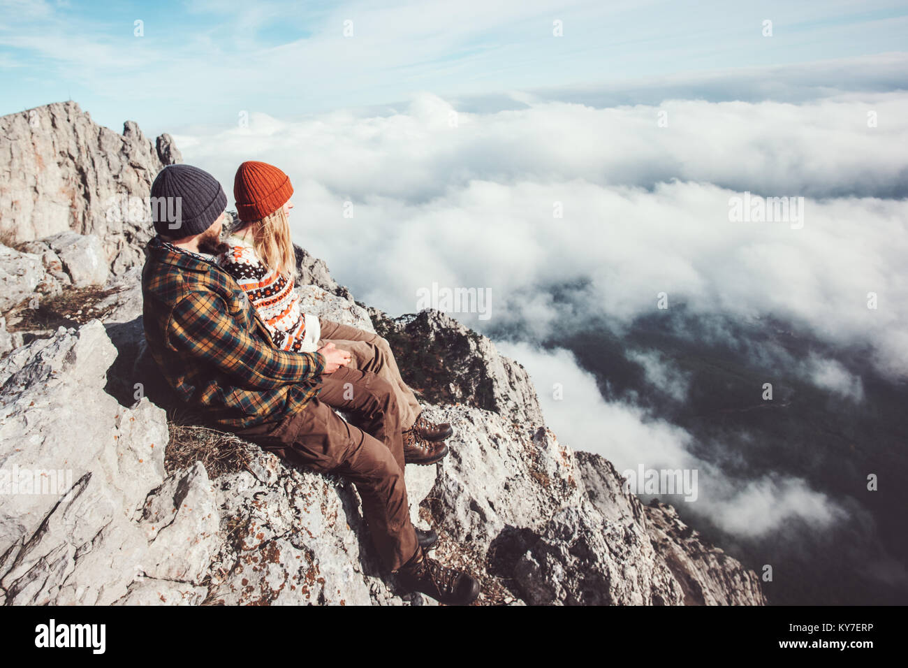 Couple travelers Man and Woman sitting on rocks relaxing mountains and ...