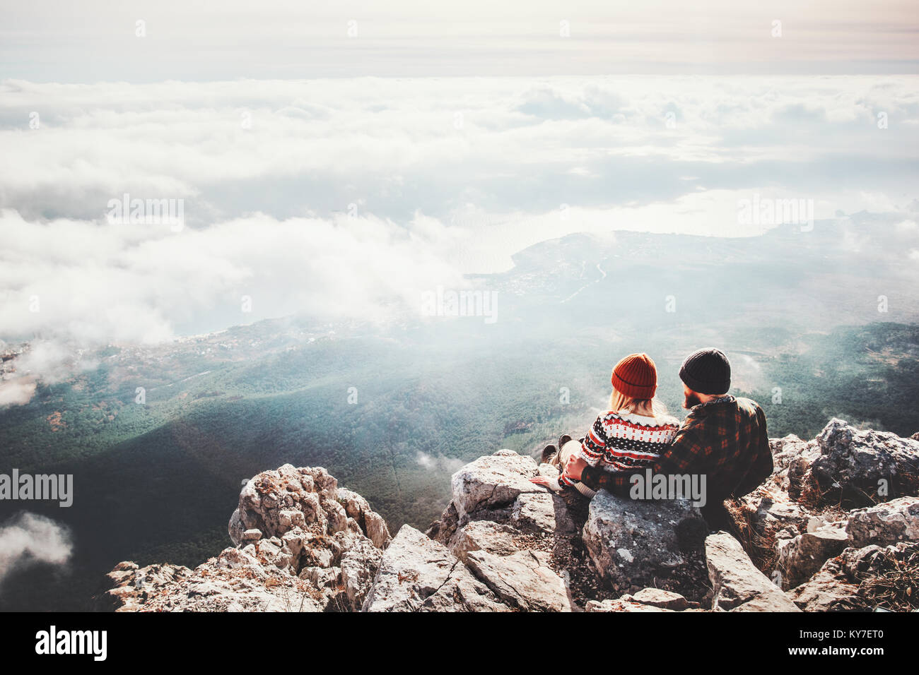 Couple travelers Man and Woman sitting on cliff relaxing mountains and ...