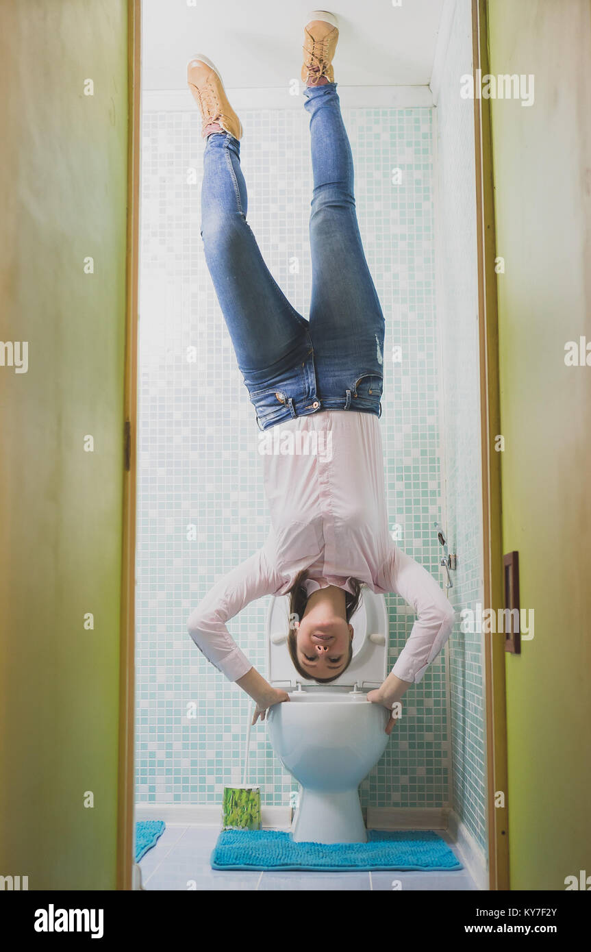 Upside down House. Woman in the toilet Stock Photo Alamy