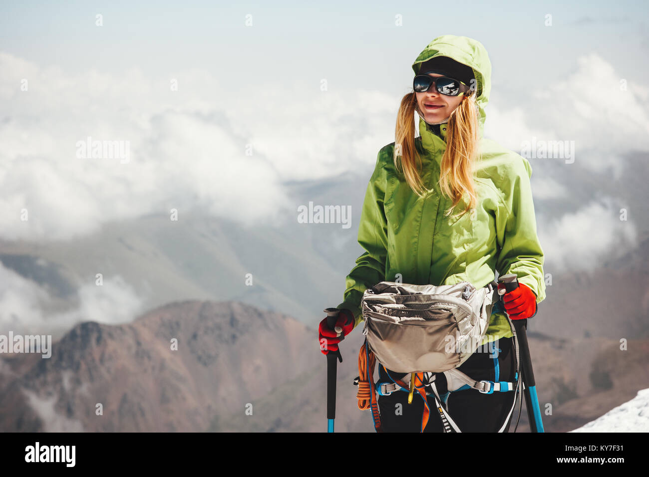 Woman climbing on mountain summit Travel Lifestyle adventure concept active vacations outdoor