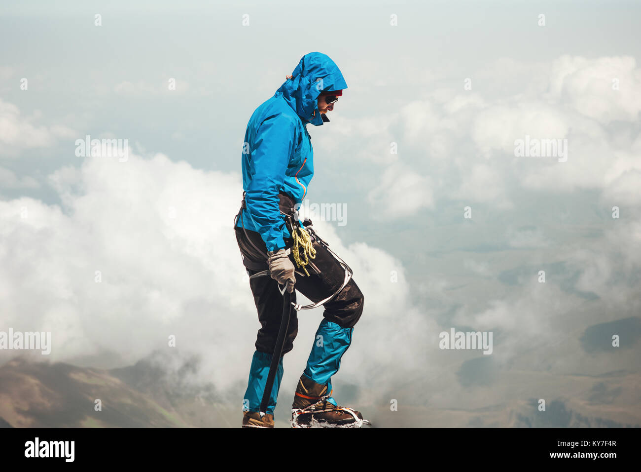 Man climbing to mountain summit Travel Lifestyle concept adventure active vacations outdoor