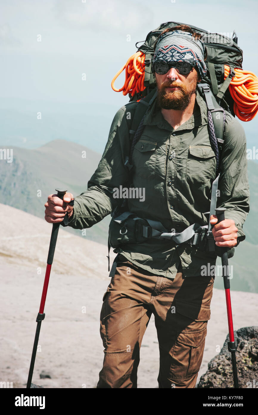 Man climbing in mountains with backpack Travel Lifestyle concept adventure active vacations