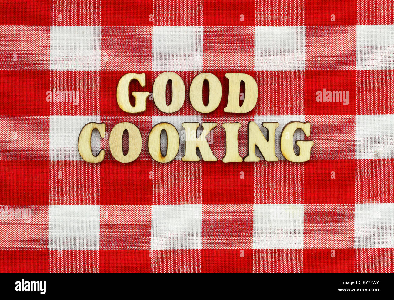 Good cooking written with wooden letters on red and white checkered ...