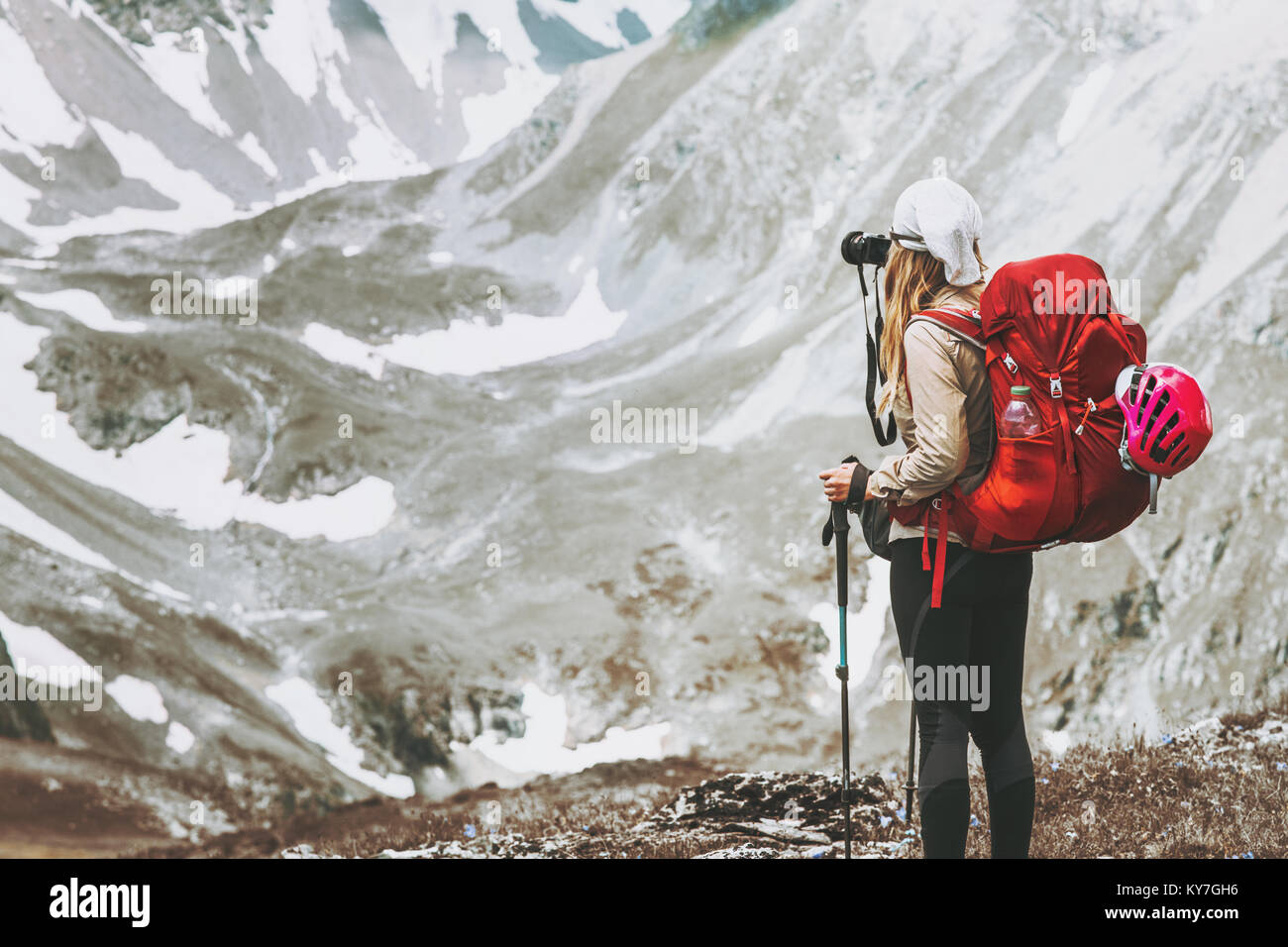 Woman traveler with photo camera hiking at rocky mountains Travel Lifestyle wanderlust concept summer vacations outdoor Stock Photo