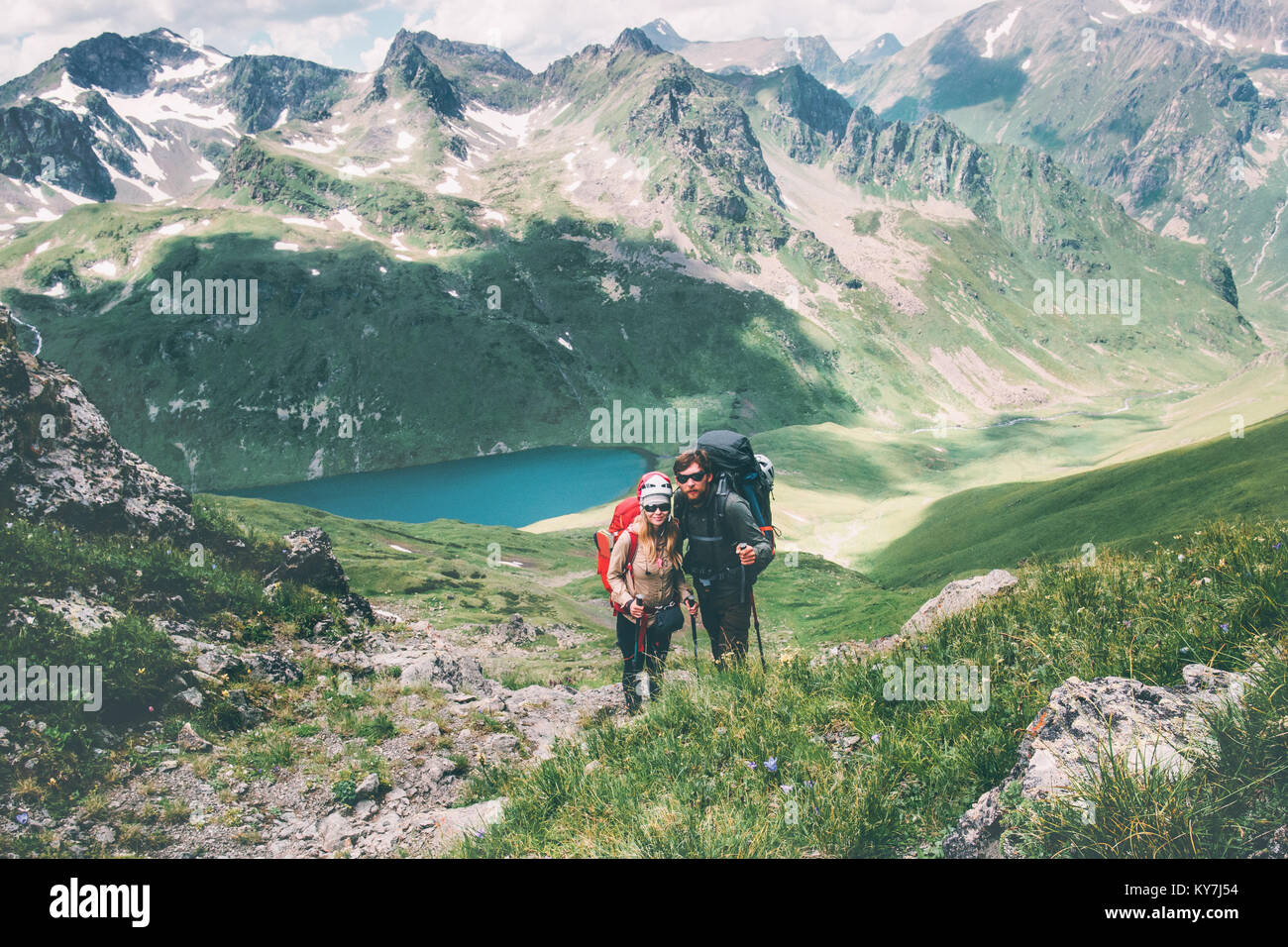 Couple travelers Man and Woman climbing in mountains Love and Travel happy emotions Lifestyle concept. Young family traveling active adventure vacatio Stock Photo