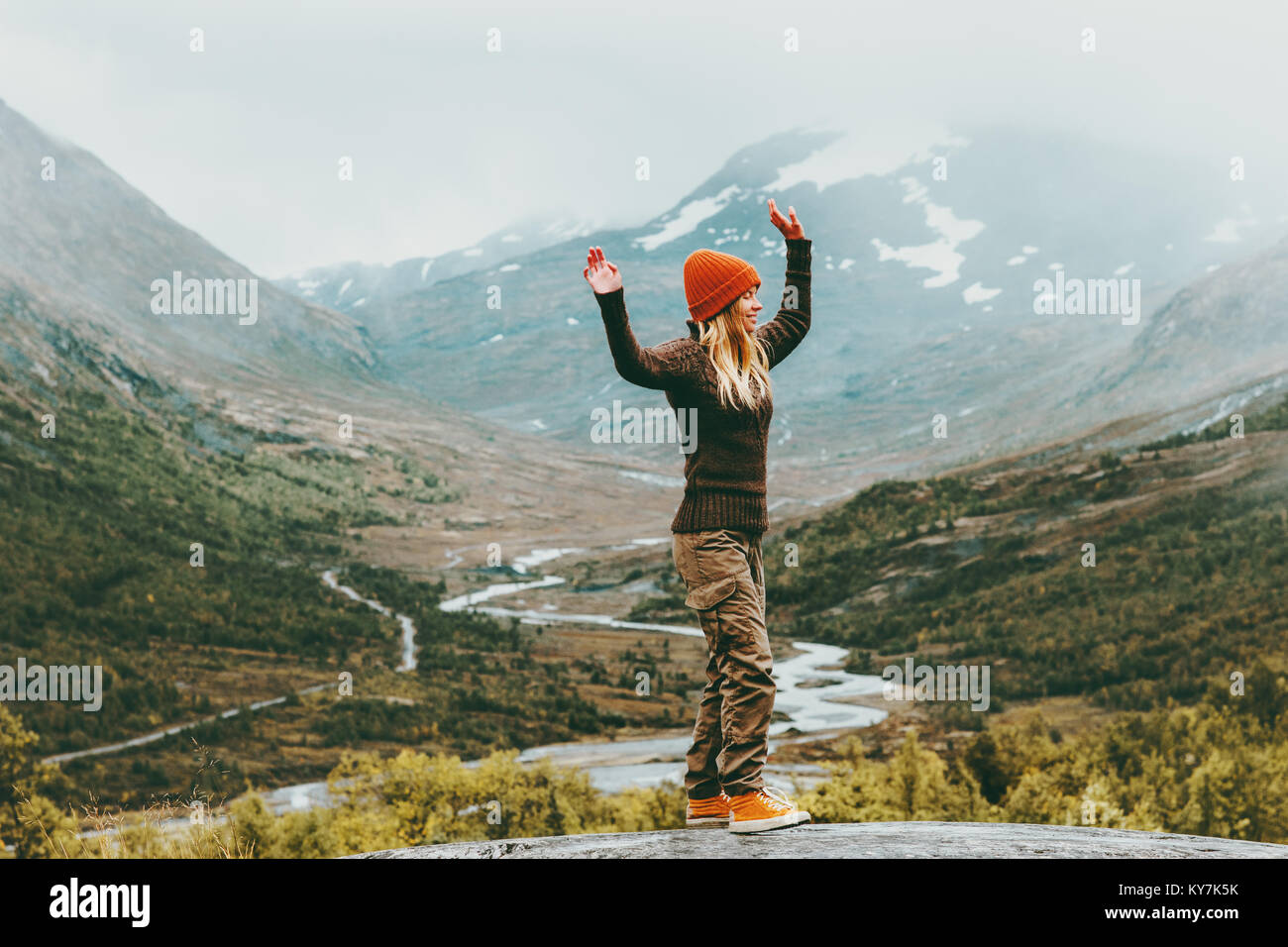 Woman walking outdoor happy emotions foggy mountains on background Travel Lifestyle success concept adventure active vacations in Norway Jotunheimen p Stock Photo