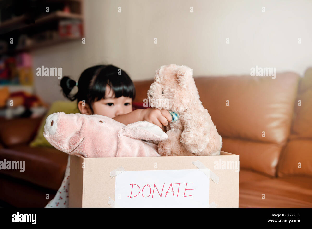 Child With Donation Concept 2 Years Old Child Putting Her Old