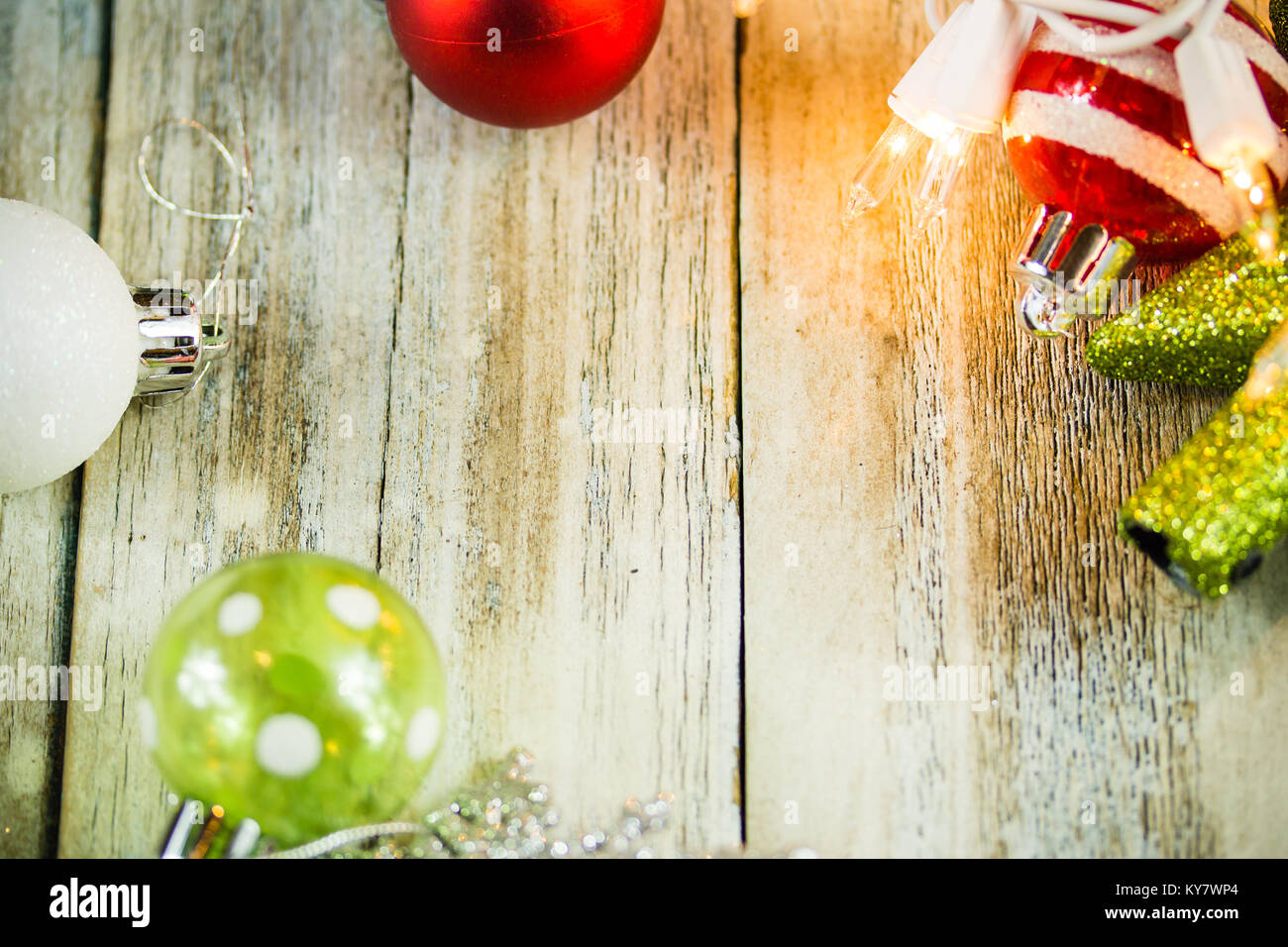 A set of Christmas holiday lights and ornaments on a white washed