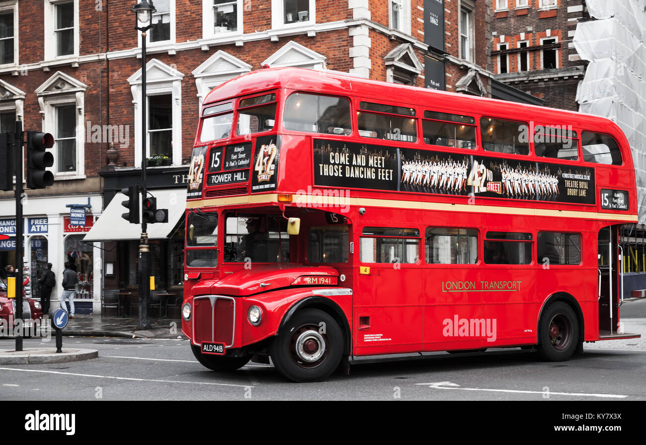London, United Kingdom - October 29, 2017: Red double-decker bus is going down the street, one of the most popular symbols of the city. Ordinary peopl Stock Photo