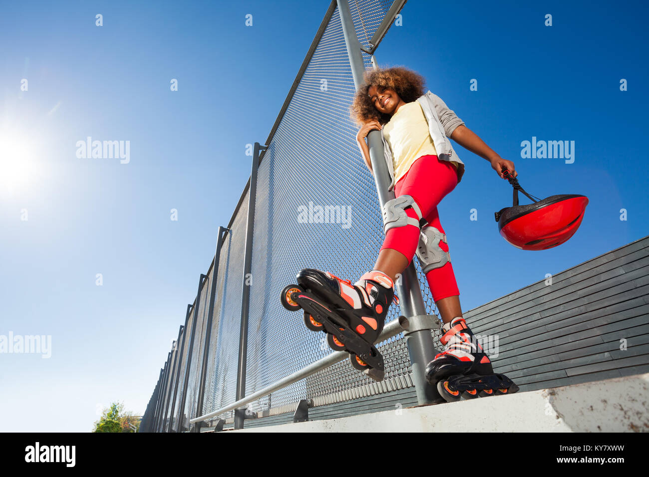 Low-angle view of preteen African girl in roller skates posing at skate  park at sunny day Stock Photo - Alamy