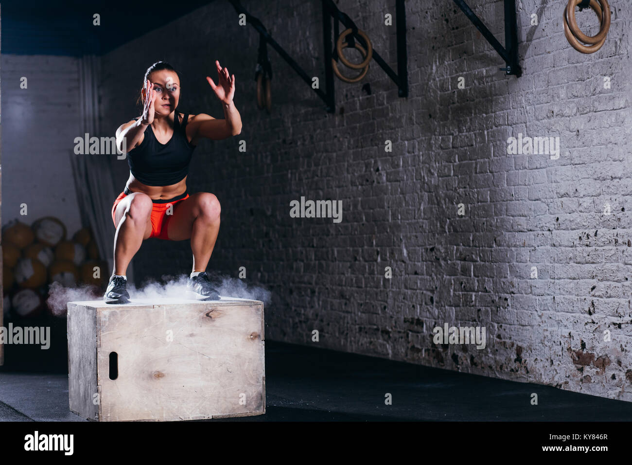 woman jumping box. Fitness woman doing box jump workout at cross fit