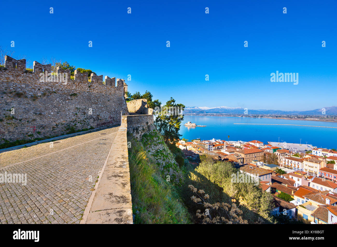 Old town of Nafplion in Greece view from above with tiled roofs, small port and bourtzi castle on the Mediterranean sea water Stock Photo