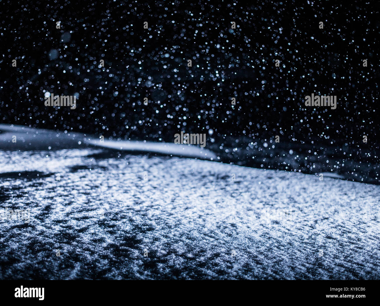 Backlighted Snow Texture during Snowstorm at Night Stock Photo