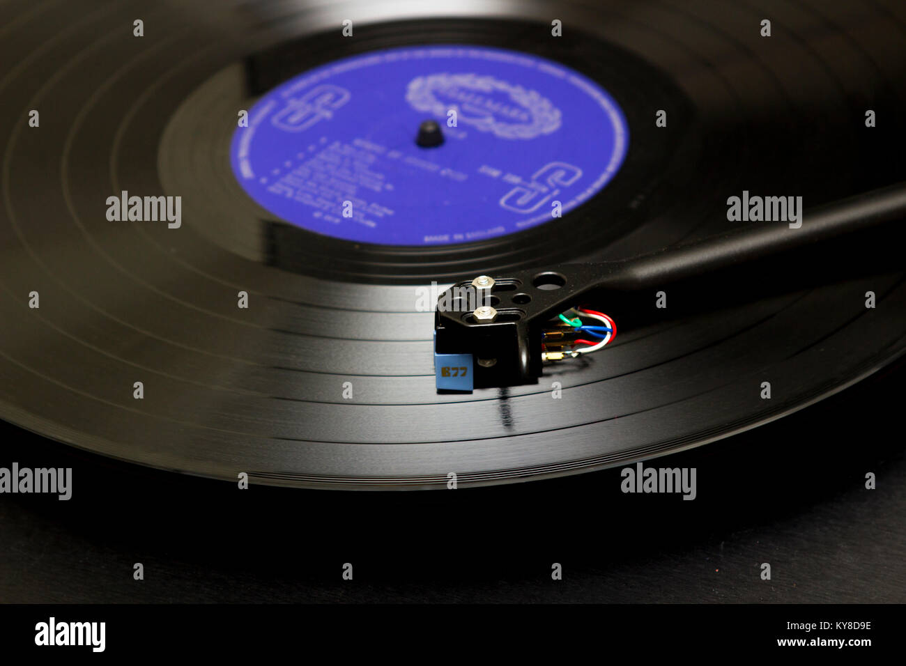 A long playing vinyl record on a turntable with tone arm and cartridge on view. The disc carries the old Hallmark Label Stock Photo