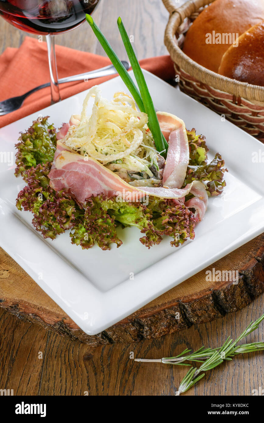 Ham salad and calamari garnished on white sqare plate Stock Photo