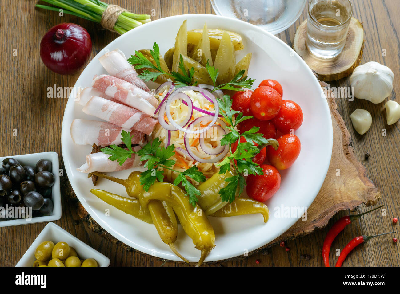 Appetizing lard and pickled vegetables garnished on white plate Stock Photo