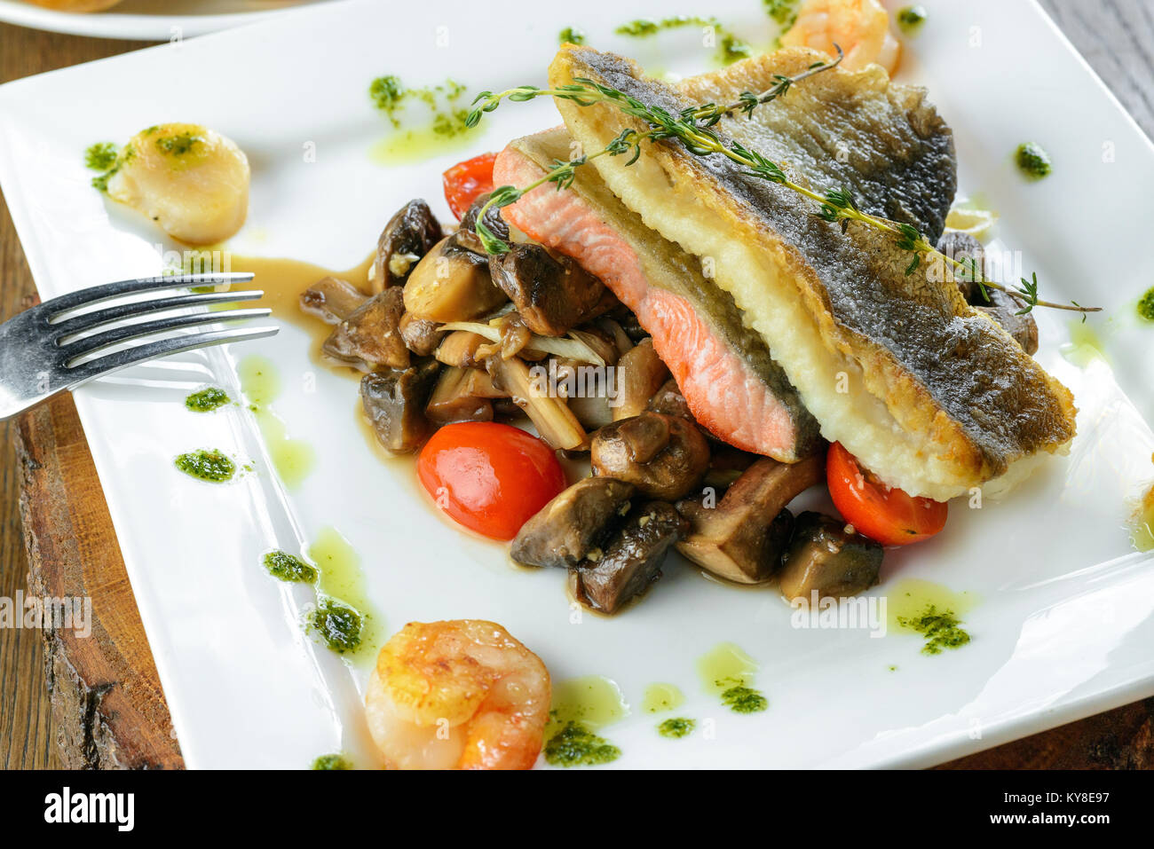 Roasted salmon with mushrooms and vegetables Stock Photo