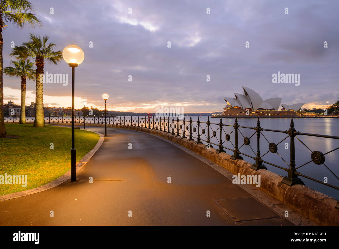 Image of the Sydney Opera House in Sydney, NSW, Australia from the boardwalk in front of Park Hyatt Sydney near Campbell's Cove Jetty at sunrise. Stock Photo