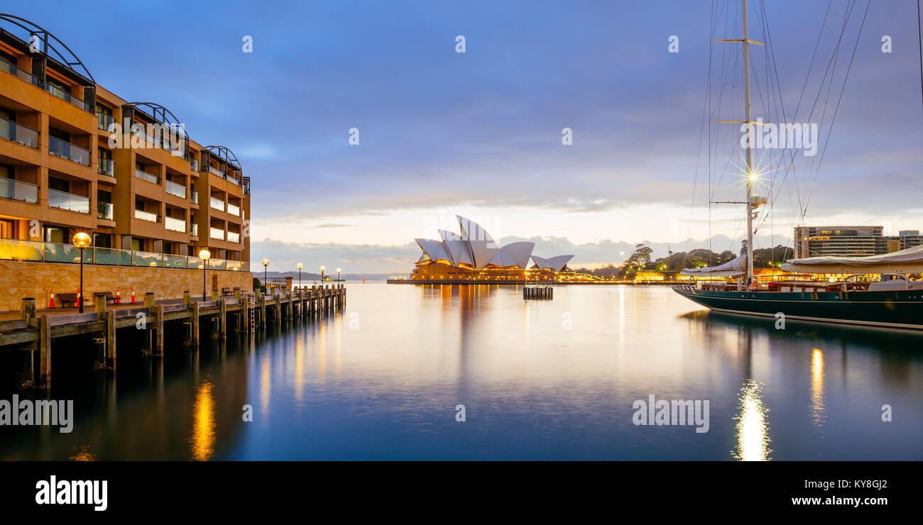Sydney Opera House in Australia from the boardwalk in front of Park Hyatt Sydney near Campbell's Cove Jetty at sunrise on a stormy morning. Stock Photo