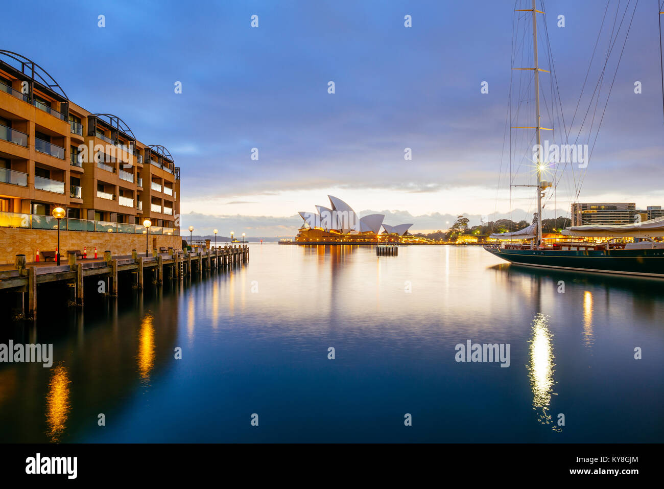 Sydney Opera House in Australia from the boardwalk in front of Park Hyatt Sydney near Campbell's Cove Jetty at sunrise on a stormy morning. Stock Photo