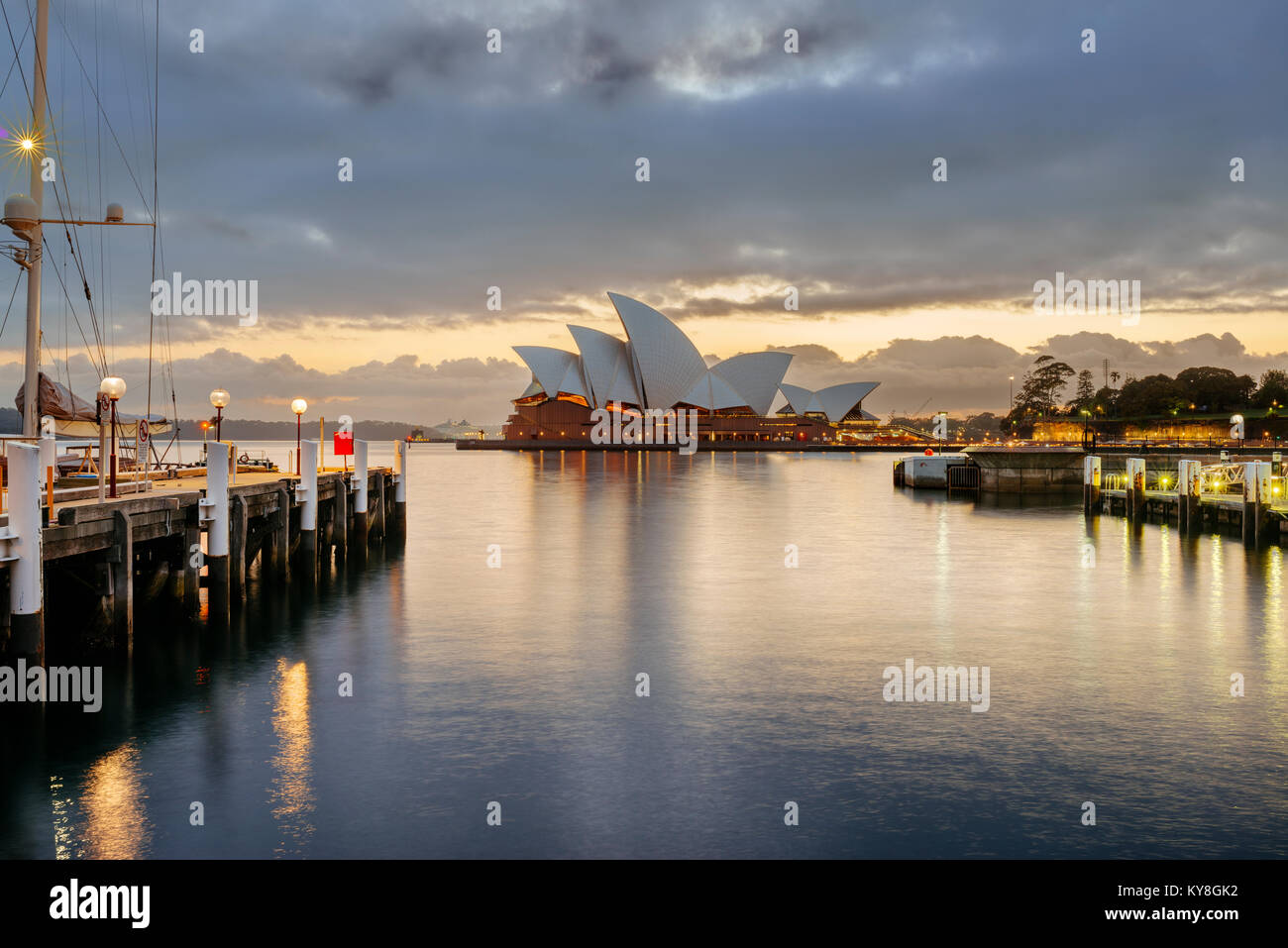 Sydney Opera House in Australia from the boardwalk in front of Park Hyatt Sydney near Campbell's Cove Jetty at sunrise on a stormy morning. Stock Photo