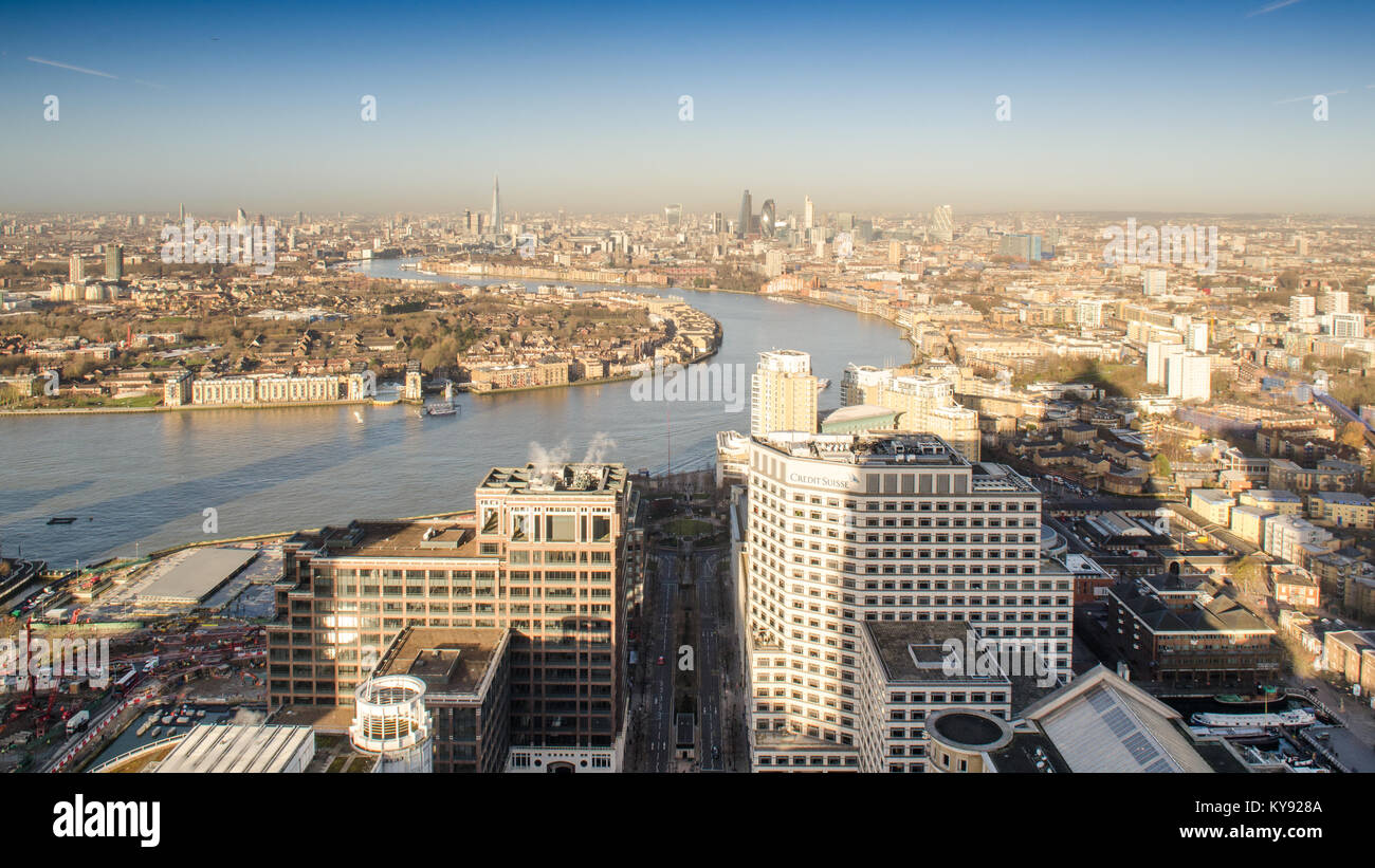 London, England, February 27, 2015: The River Thames meanders through the cityscape of East London as seen from the Docklands Canary Wharf Tower. Stock Photo