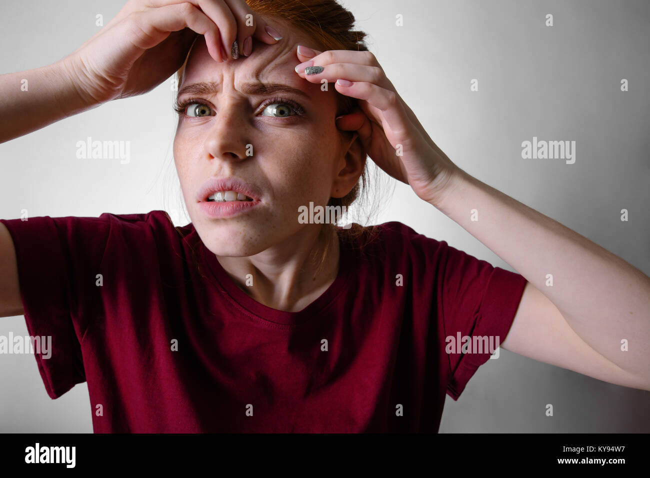 redhead woman squeezing her pimples, removing pimple from her face Stock Photo Alamy