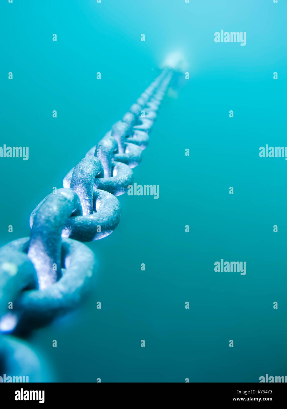 shallow focus view of underwater anchor chain in perspective, receding into the distance Stock Photo