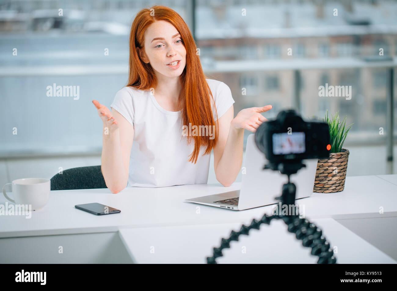 Female Vlogger Recording Broadcast At Home with laptop Stock Photo