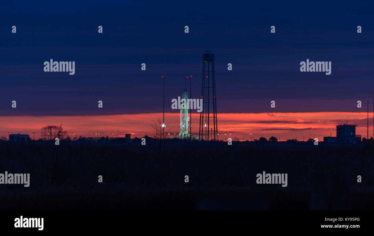 Orbital ATK's Antares launch vehicle sits on launch pad 0 at the Mid-Atlantic Regional Spaceport as dawn breaks on the horizon prior to a launch Stock Photo
