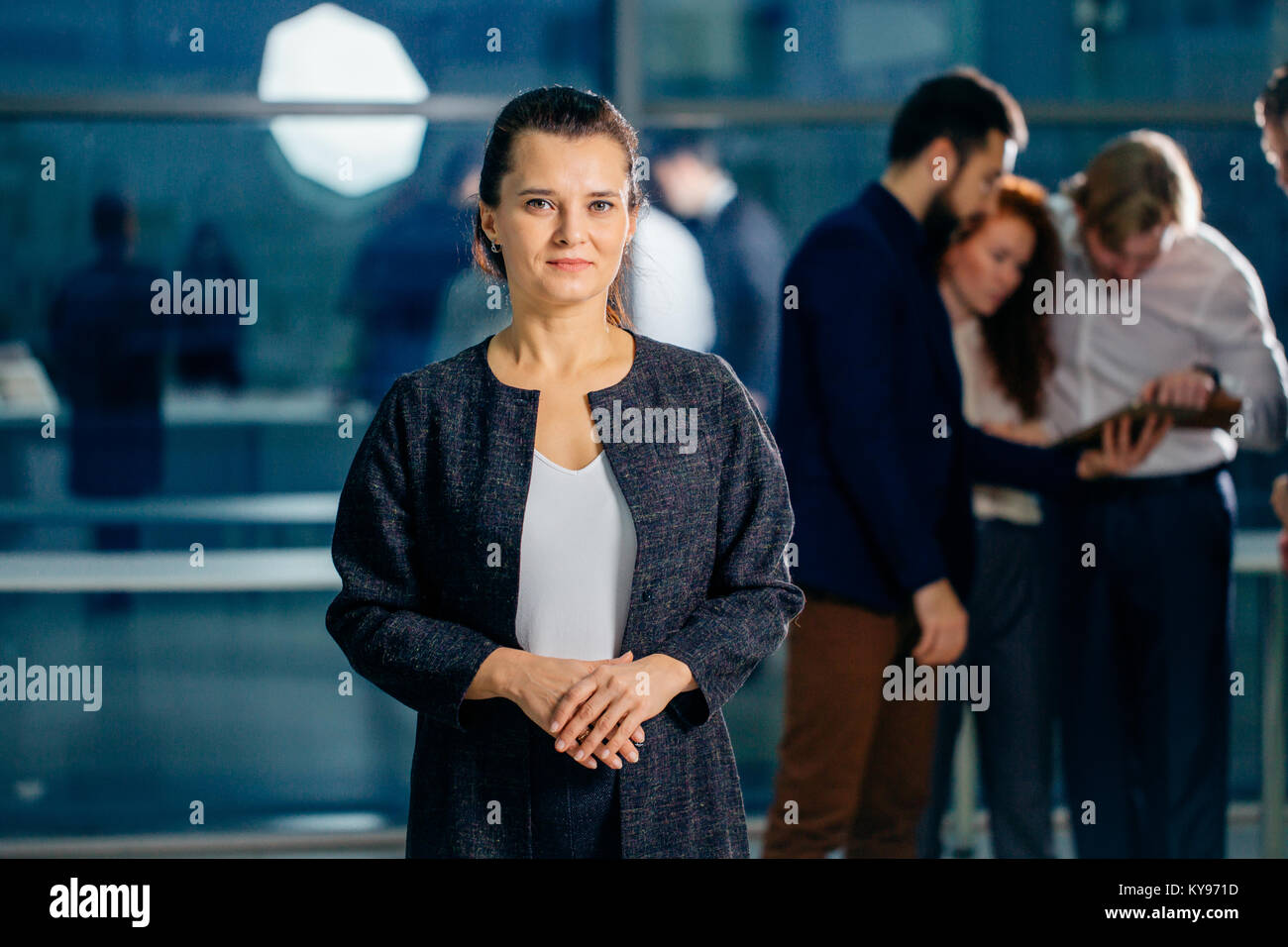 beautiful woman on the background of business people Stock Photo - Alamy