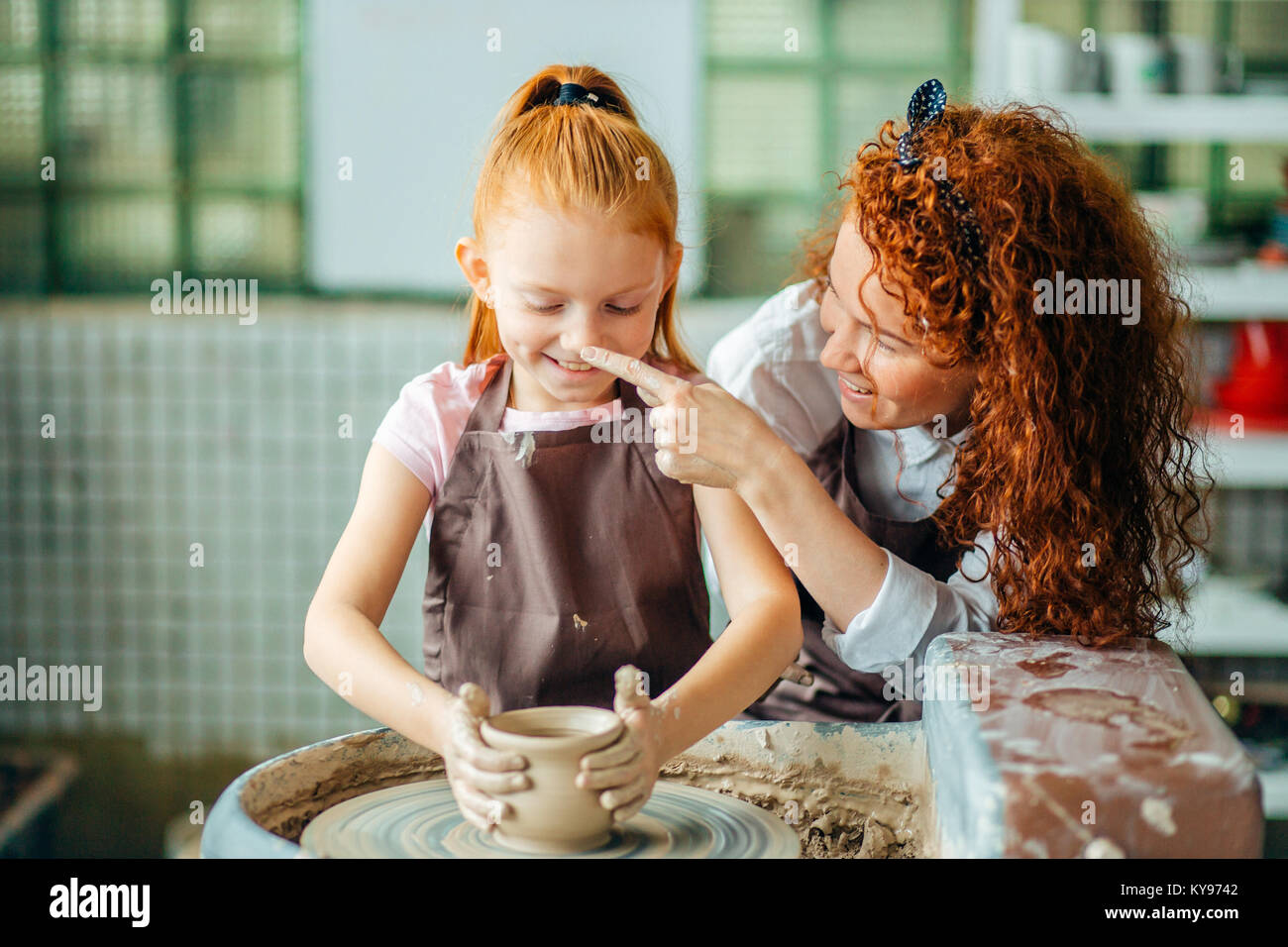 teacher and student make pitcher of pottery wheel Stock Photo - Alamy