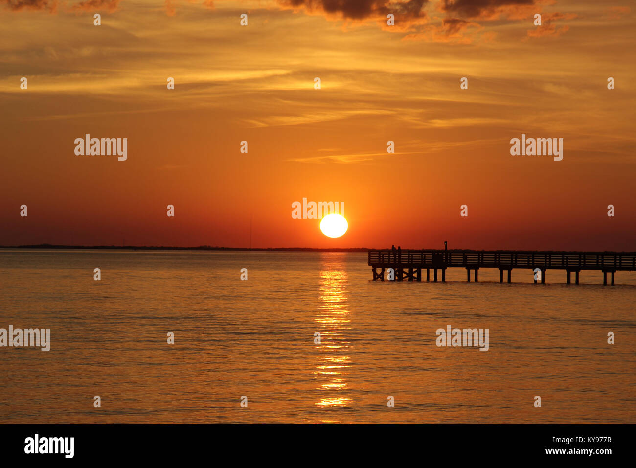 Charlotte Harbor sunset with golden sky and silhouetted fishing pier, Florida USA. Stock Photo