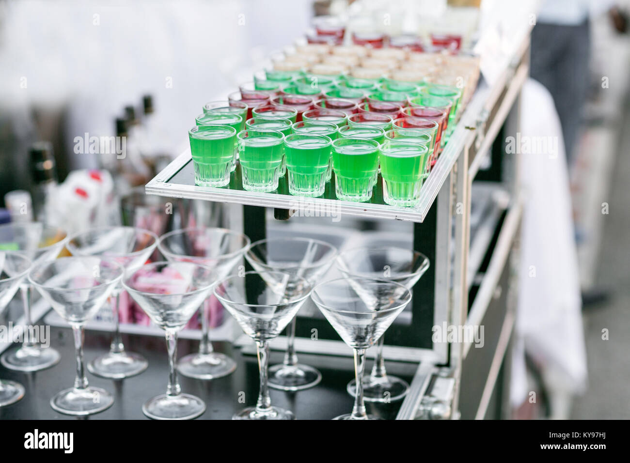 row line of different colored alcoholic cocktails on a party. wedding day or birthday Stock Photo
